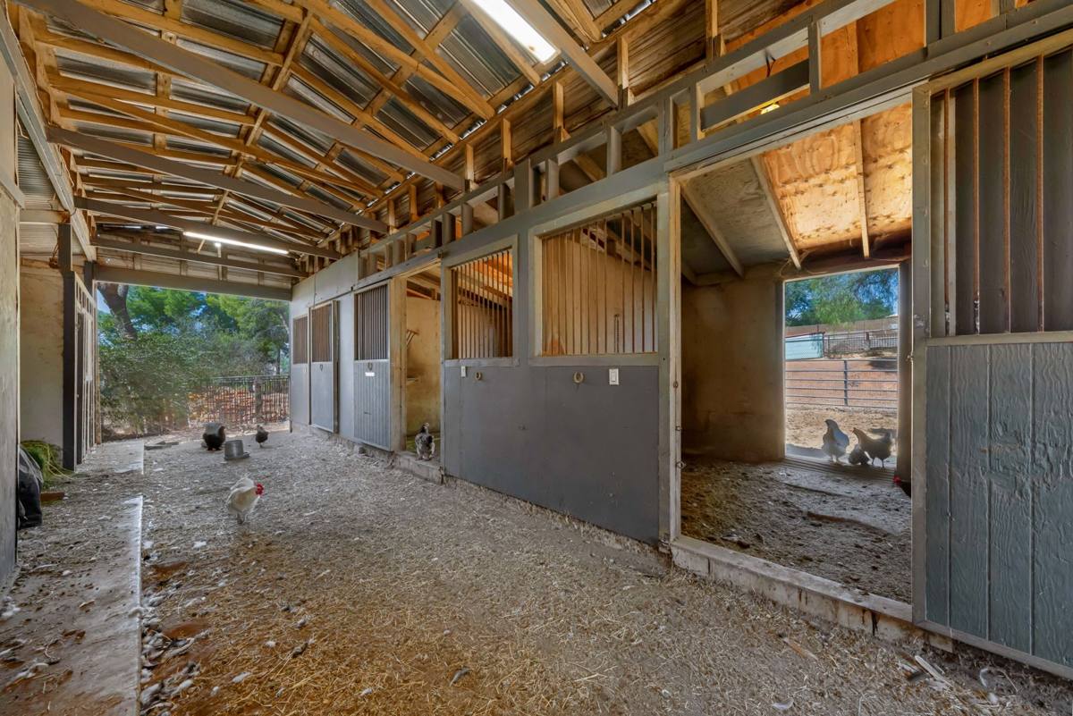 Barn with covered aisle and horse stalls