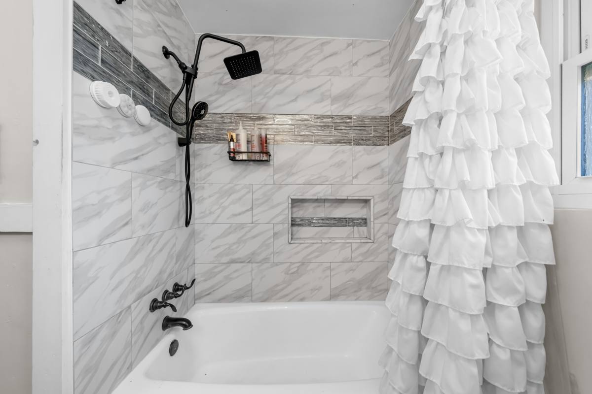Tiled tub and shower with rain shower head