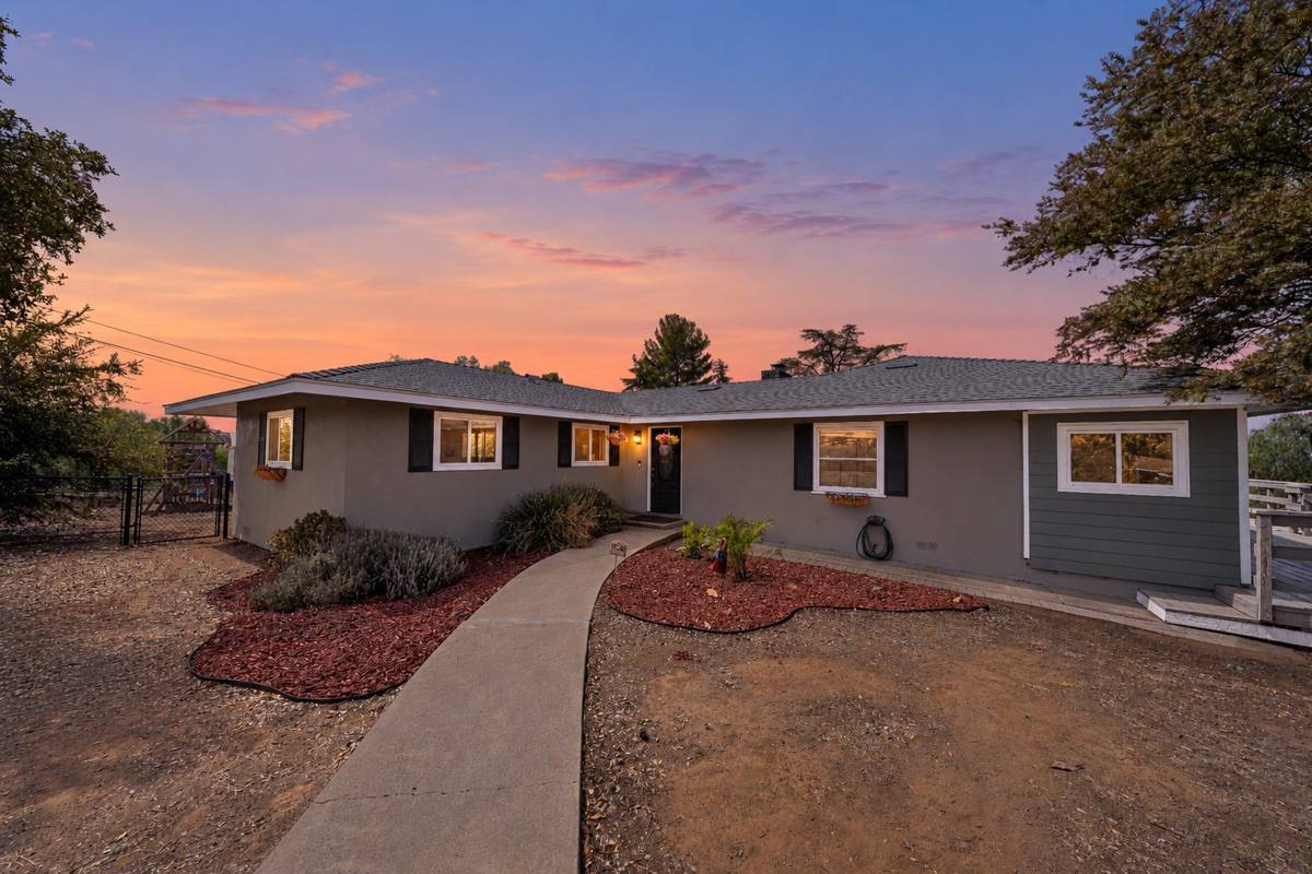 Single-story home at twilight with curved walkway