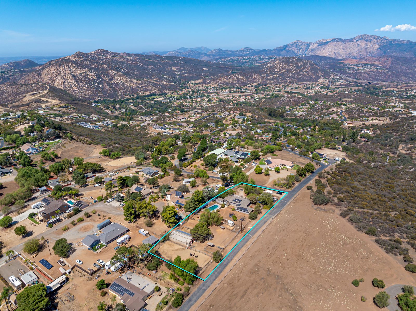 Aerial view of 2110 Via Corina on 1.5 acres with the mountains of Alpine in the background