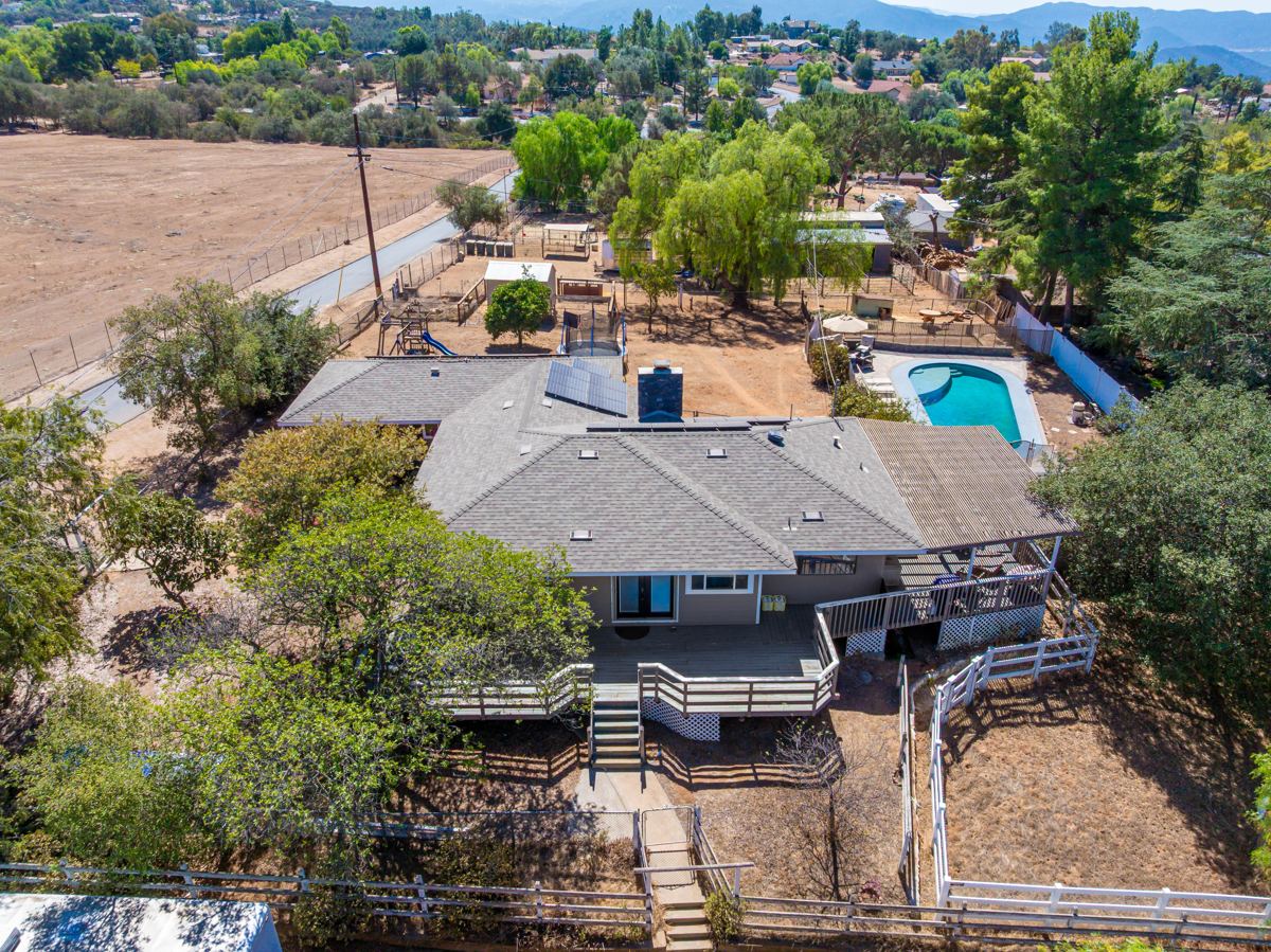 Original, unaltered overhead aerial of the home, deck, and pool